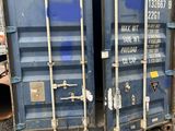 deux conteneurs d'expédition bleus posés côte à côte au sol