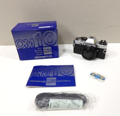 the camera is sitting on the table next to the box