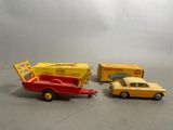 two toy cars that are next to each other on a table