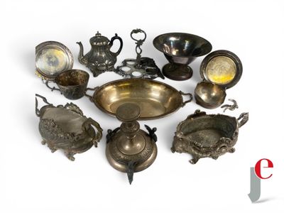 a lot of antique silverware on display on a table