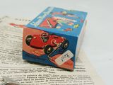 a toy car sitting on top of an open book