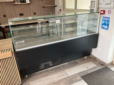 a glass display case in the middle of a store
