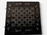 a picture of a black and white chess board on a white surface