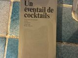a book on the floor next to a bottle of alcohol