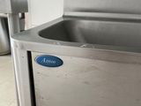 a stainless steel sink with a blue sign on it
