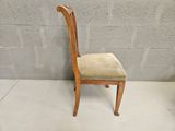 an image of a wooden chair with a beige upholstered seat