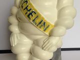 a statue of a man with a sash sitting on a table