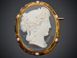 an image of a woman ' s profile is shown in a gold broocher
