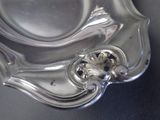 a silver plate with a decorative design on it
