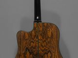 a close up of an acoustic guitar on a gray background