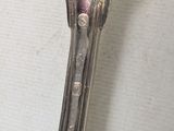 a silver spoon with a spoon handle on it