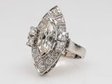 a white gold and diamond ring with a pear shaped center