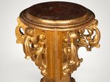 an image of a gold pedestal with a marble top on a white background