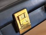 a close up of a black suitcase with a gold handle