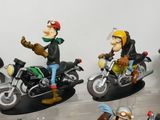 many figurines of people riding motorcycles on display