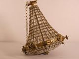 a gold and silver bird hanging from a chain