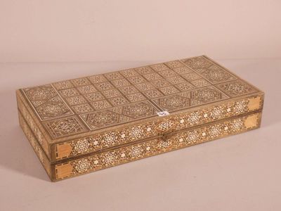 an ornate wooden box with intricate designs on the lid
