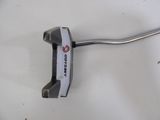 a close up of a golf putter on a white surface