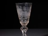 a glass that is sitting on a table in the dark