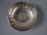 a silver plate with a flower design on it