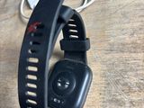 a smart watch on a wooden table with a charger