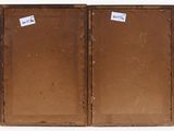 two open suitcases with stickers on them sitting on a white surface