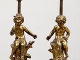 pair of antique bronze figurines of a boy and a girl on marble bases