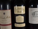 several bottles of wine are lined up on a shelf