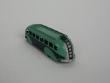 a toy bus that is sitting on a white surface