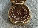an image of a gold medal with a clock on it