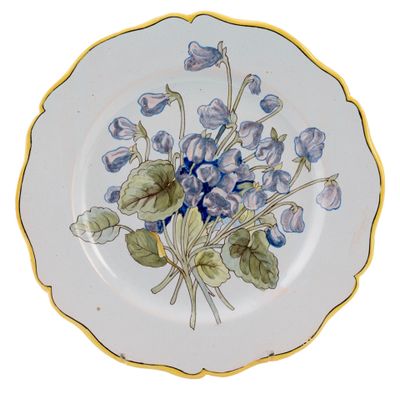 a plate with blue flowers on it on a white background