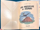 someone is holding a book with a picture of a plane flying over a mountain