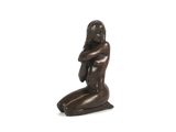 statue représentant une femme assise sur ses genoux, les bras croisés