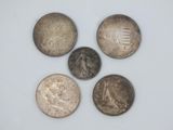four different types of coins are shown on a white surface