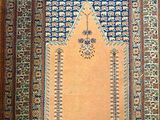 an oriental rug with a blue and white design on a wooden floor