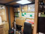 a room with a lot of boxes and a chair in it