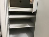 an open refrigerator that is sitting in the corner of a room