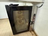 a small oven that is in the corner of a room