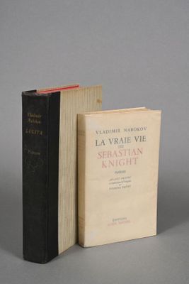 two books sitting next to each other on a gray surface