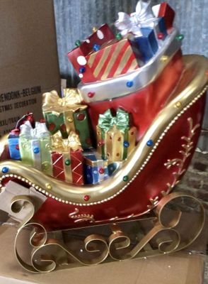 a christmas sleigh with presents on top of it