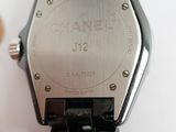 a close up of a watch on a white surface