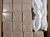 a cardboard box with a bunch of white napkins in it