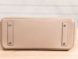 a close up of a purse sitting on a wooden table