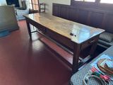 a large wooden table in the middle of a living room