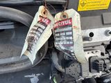 two tags attached to the engine of a car