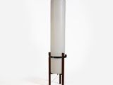 an image of a tall lamp with a white cylinder on a wooden stand