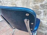 an image of a black chair with a blue seat