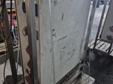 a refrigerator that is sitting on a pallet in a warehouse