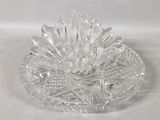a clear glass bowl with a flower inside of it