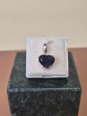 a close up of a pendant on a box on a table